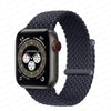 A dark gray braided stretch band worn around an Apple Watch.