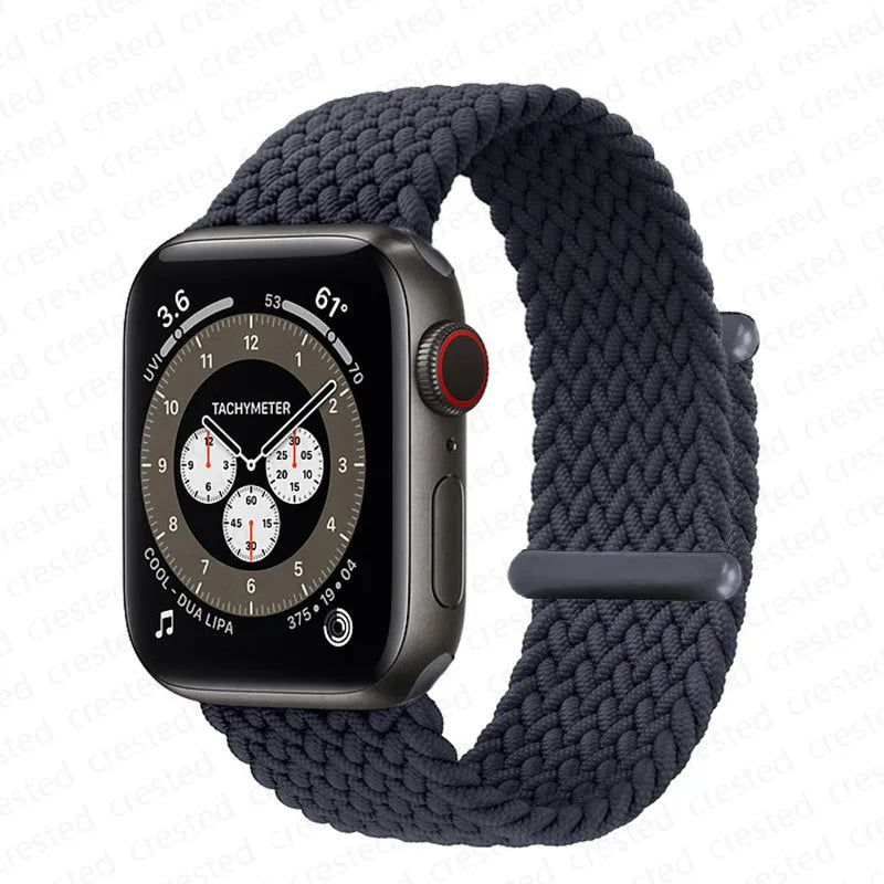 A dark gray braided stretch band worn around an Apple Watch.
