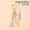Gold-toned seashell starfish keychain with pink and white pearl accents