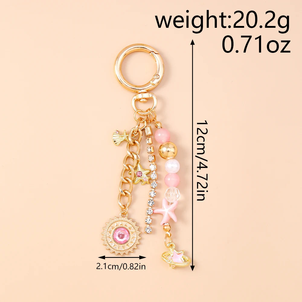 Gold-toned seashell starfish keychain with pink and white pearl accents