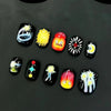A set of cute cartoon press-on nails featuring various designs including a tree, yellow dots, and expressive faces on black t