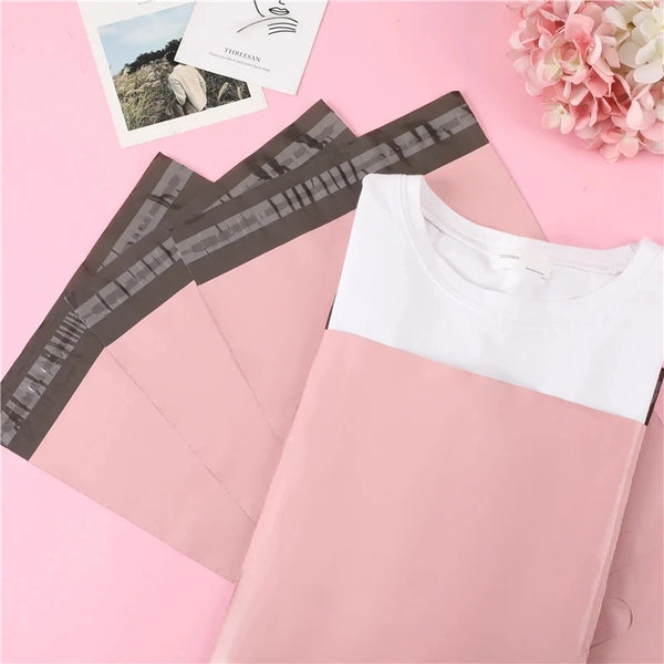 Pink self-adhesive storage bags for shipping and packing displayed on a pink background.