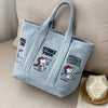 Light blue canvas shoulder bag featuring Snoopy cartoon graphics for women