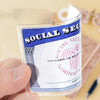 A hand holds a clear PVC card and ID sleeve featuring the Social Security Administration logo and text.