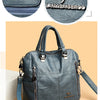 A dark gray leather crossbody backpack bag with silver hardware and a matching strap.