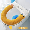 A beige plush waterproof toilet seat cover featuring a bear and a panda design.