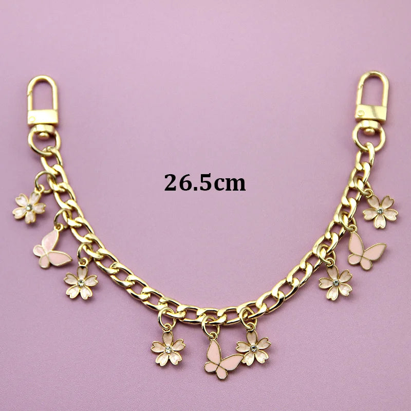 Gold chain necklace with pink bag flower charms and butterfly charms