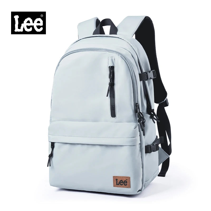 A light blue Lee oxford school backpack with a black strap and laptop sleeve.