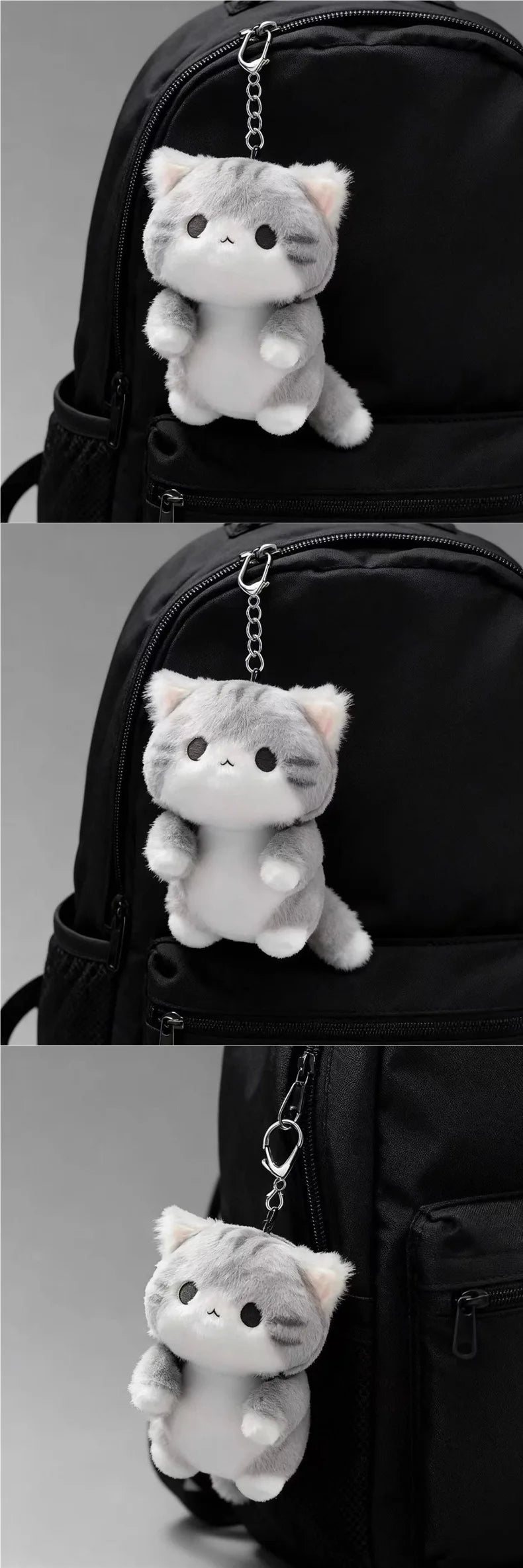 A grey soft cat plush pendant ornament hanging from a keychain on a black backpack.