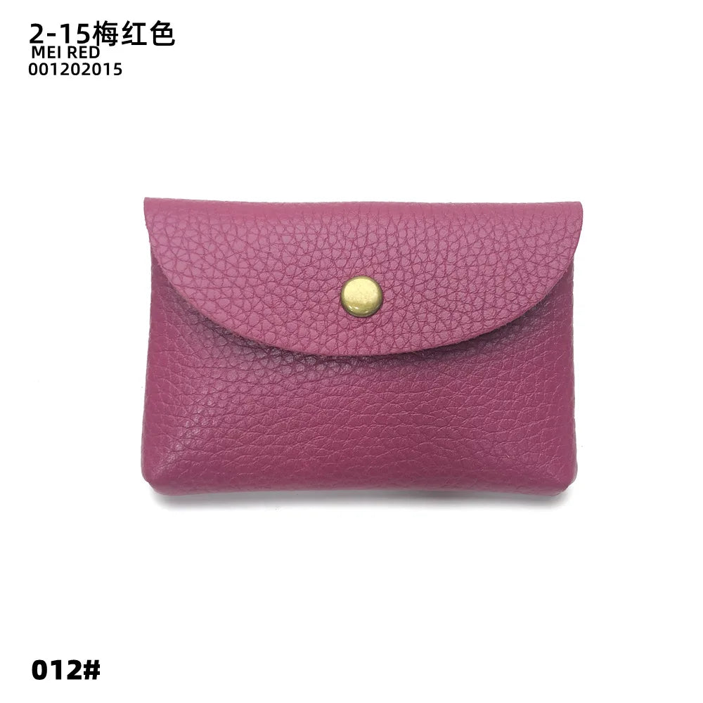 A mauve pink genuine leather card holder with a gold stud closure.