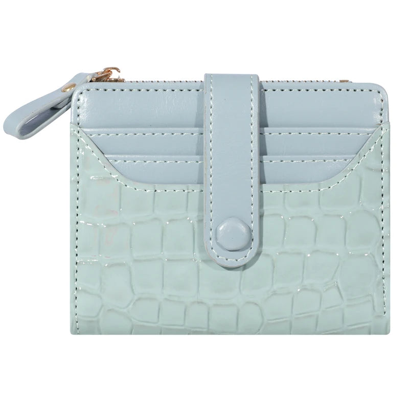 A light blue crocodile print card wallet with a flap closure and double zip on the top.