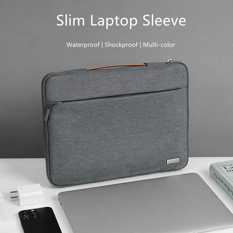A gray multi-pocket laptop sleeve with an orange handle is shown next to a silver laptop.