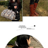A woman holds a patterned PU leather travel duffel bag outdoors.