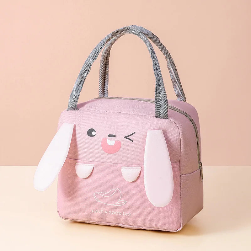 A pink cartoon insulated lunch bag featuring a smiling duck face and a small dove design.