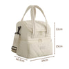 A cream-colored double-layer insulated lunch bag with carrying handles and zippered compartments.