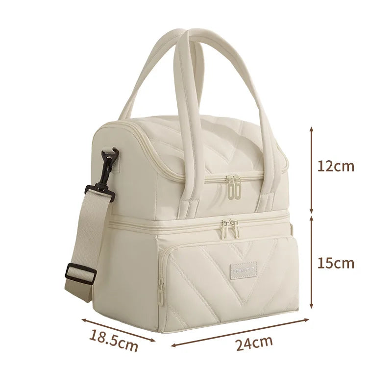 A cream-colored double-layer insulated lunch bag with carrying handles and zippered compartments.