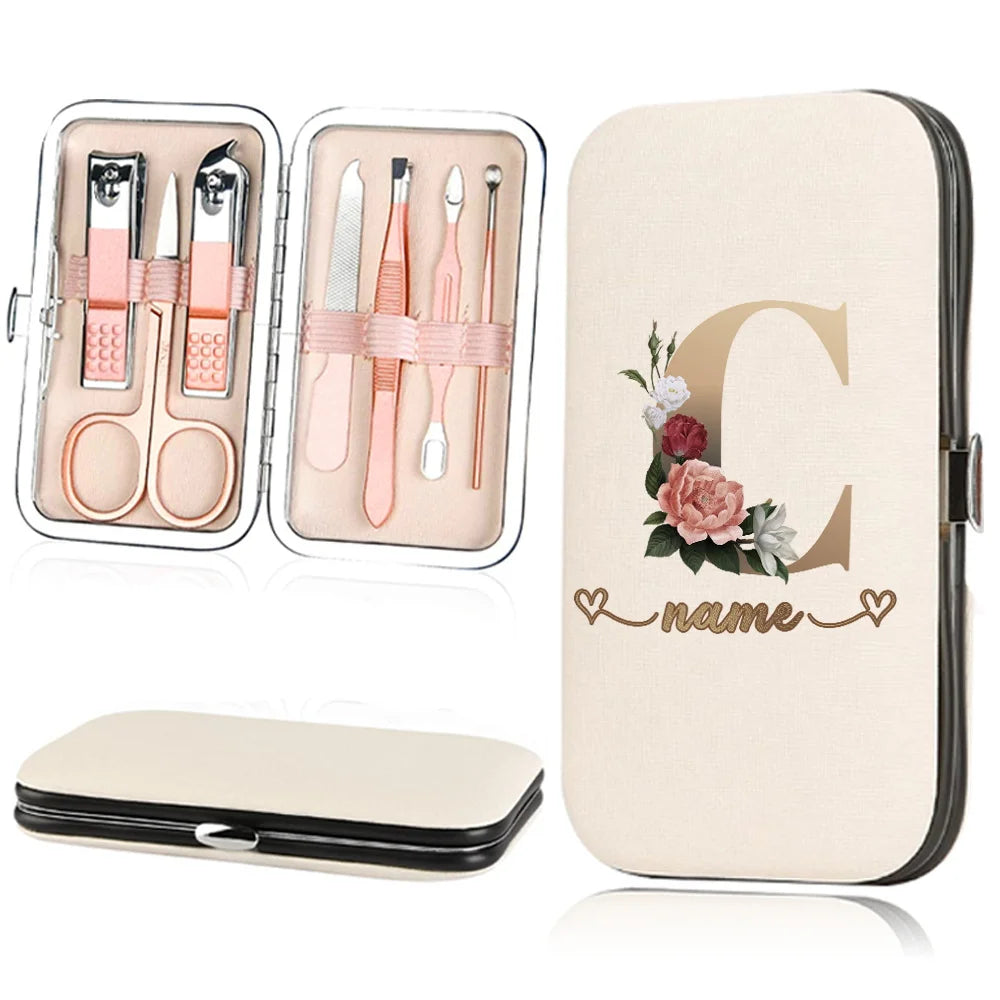 A beige cosmetic case holding a stainless steel nail clipper set with various tools and a large letter C design.
