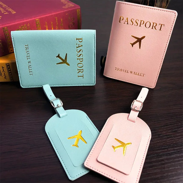 Pink and teal PU leather passport holders with gold airplane emblems displayed on a dark surface.