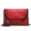 A red leather flap crossbody bag with a silver chain strap.