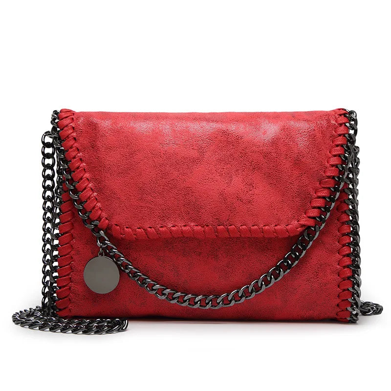 A red leather flap crossbody bag with a silver chain strap.