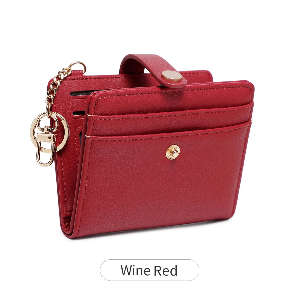 A minimalist wallet in wine red leather with gold hardware shown against a white background.