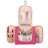 Pink multi-compartment travel pouch with floral print for organizing cosmetics and toiletries
