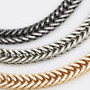 Close-up view of three metal bag chain straps in silver, gold, and dark gray finishes.