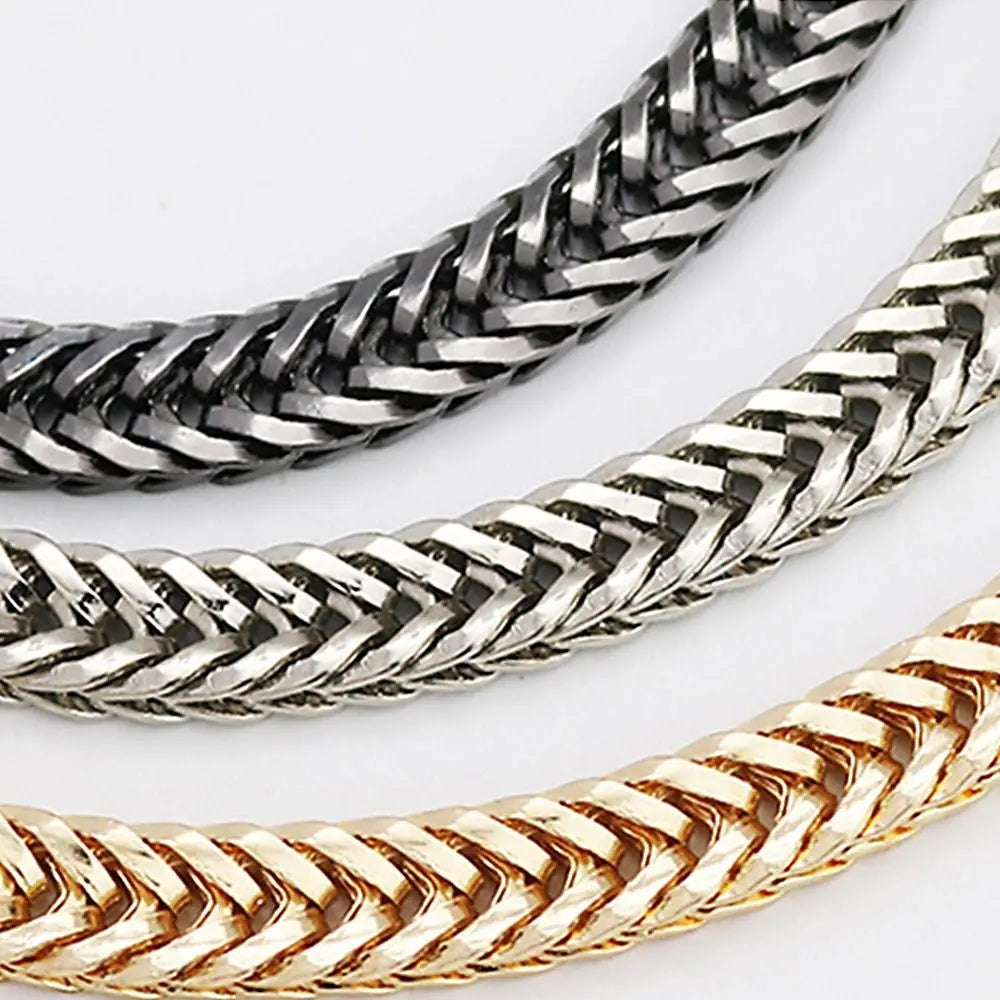 Close-up view of three metal bag chain straps in silver, gold, and dark gray finishes.