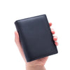 A hand holds a black genuine leather men's business wallet with a zipper.