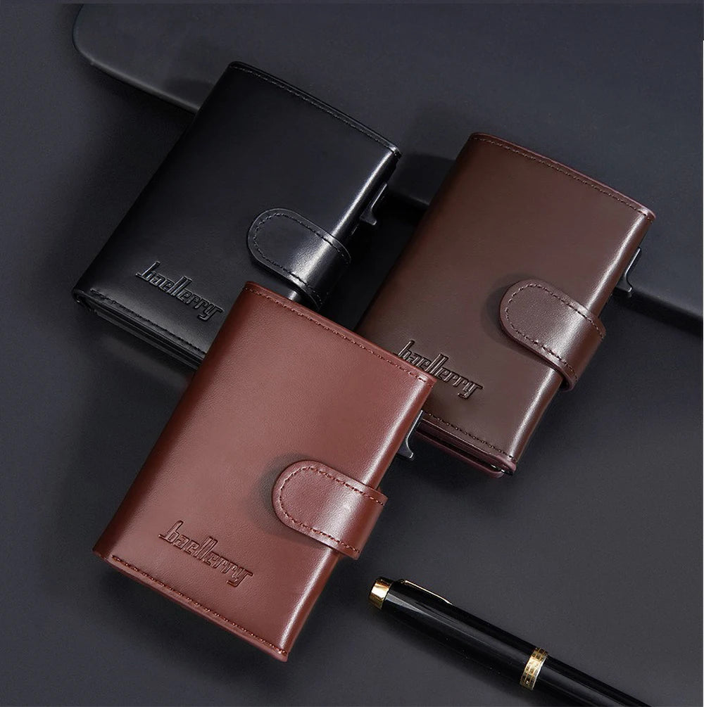 A brown leather card holder and a black leather wallet are displayed on a dark surface.