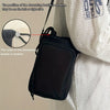 A black adjustable water bottle carrier bag is shown on a person, highlighting random placement of the drawstring buckle and 