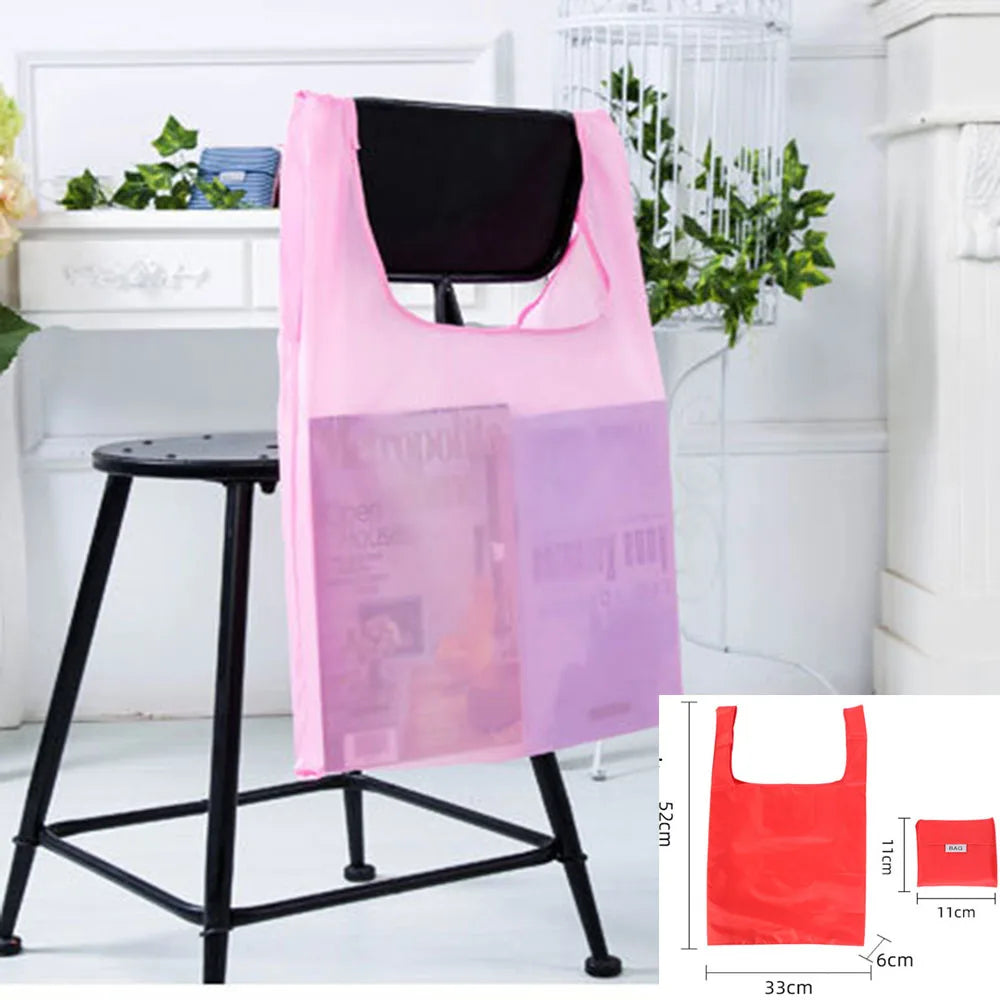Pink and purple reusable plastic shopping bags displayed on a black stand.