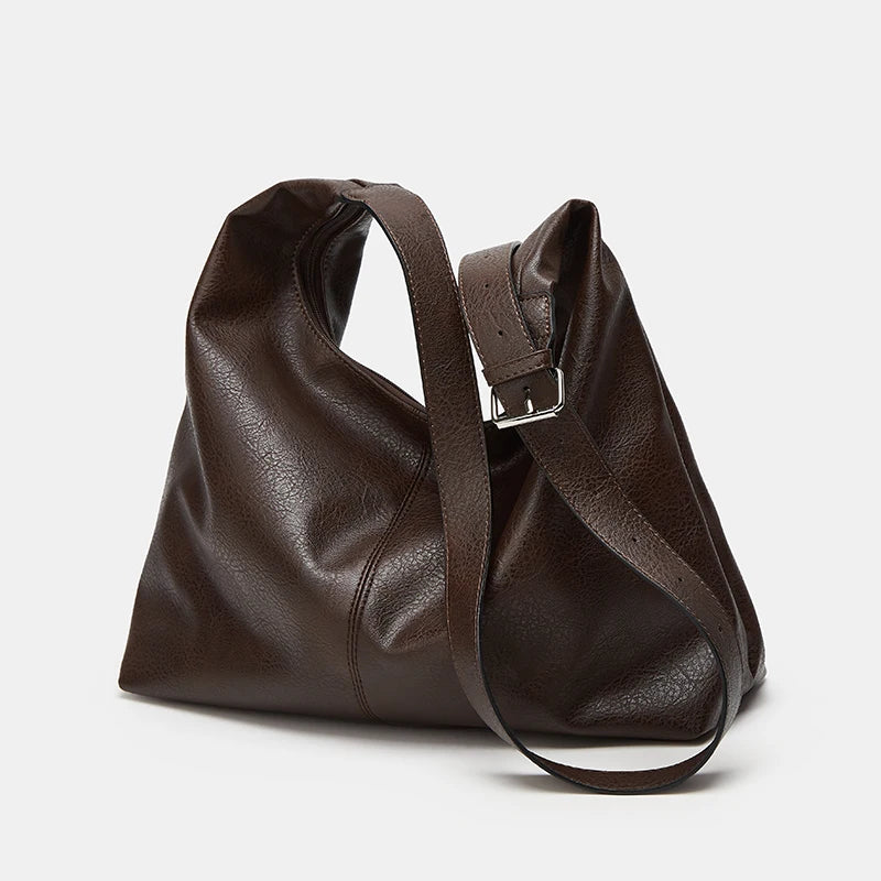 A dark brown soft PU leather retro tote bag with a zipper closure shown from the side.