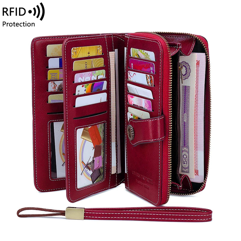 A maroon RFID protection multi-card wallet with a wrist strap, showing various cards inside.