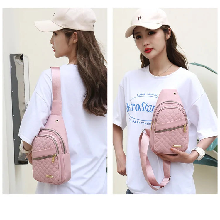Eine Frau modelliert eine pinke wasserdichte Crossbody-Umhängetasche vor einem weißen Hemd.