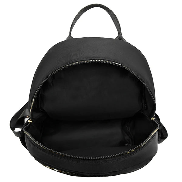 Black breathable quilted faux leather daypack with a top handle and open flap.