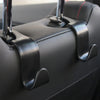 Close-up of black car seat back hooks used for trunk organization.