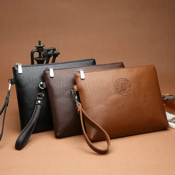 A set of three women's PU leather clutch bags in black, brown, and tan leather.