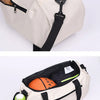 A beige waterproof sports duffel bag with a black strap and a tennis ball inside.