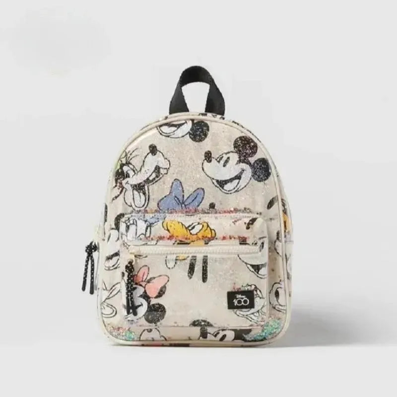 A beige fashion backpack featuring a cow print design with Mickey Mouse motifs.