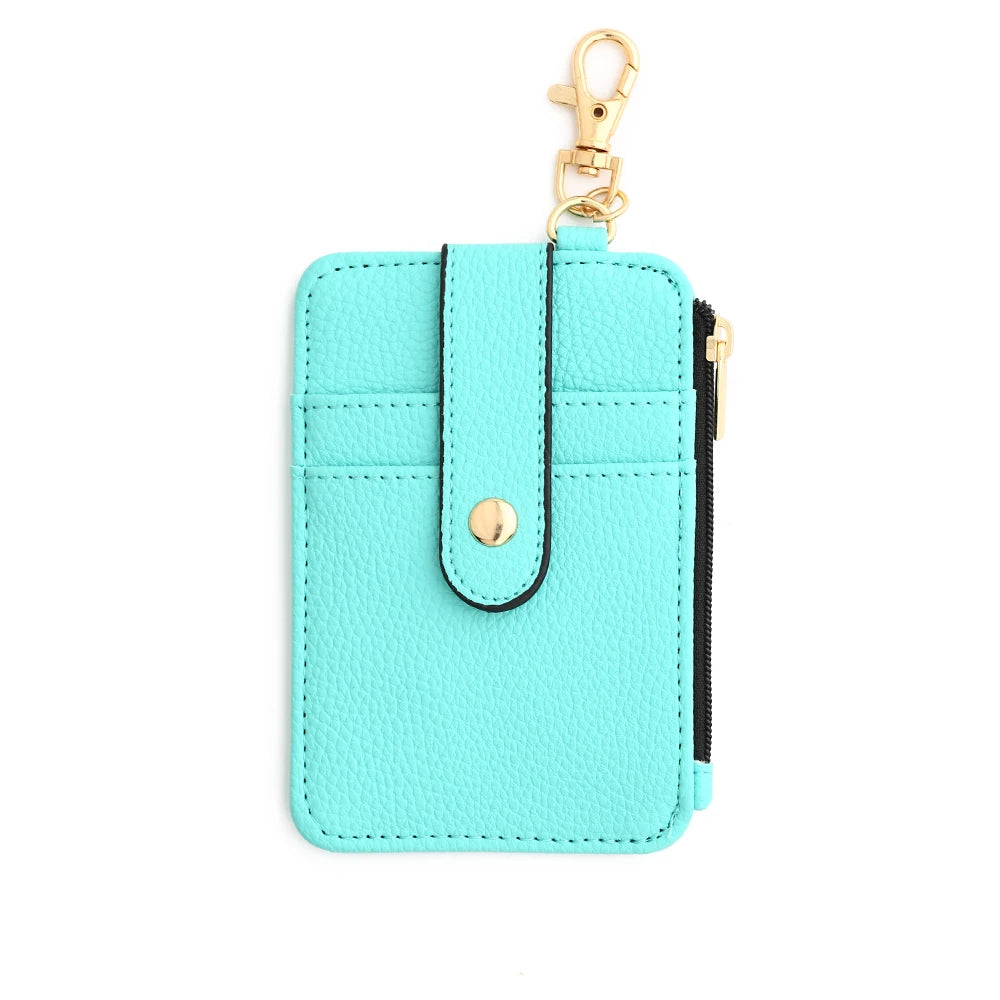 A light turquoise silicone PU leather key chain wristlet wallet with a gold-tone clasp and black zipper detail.