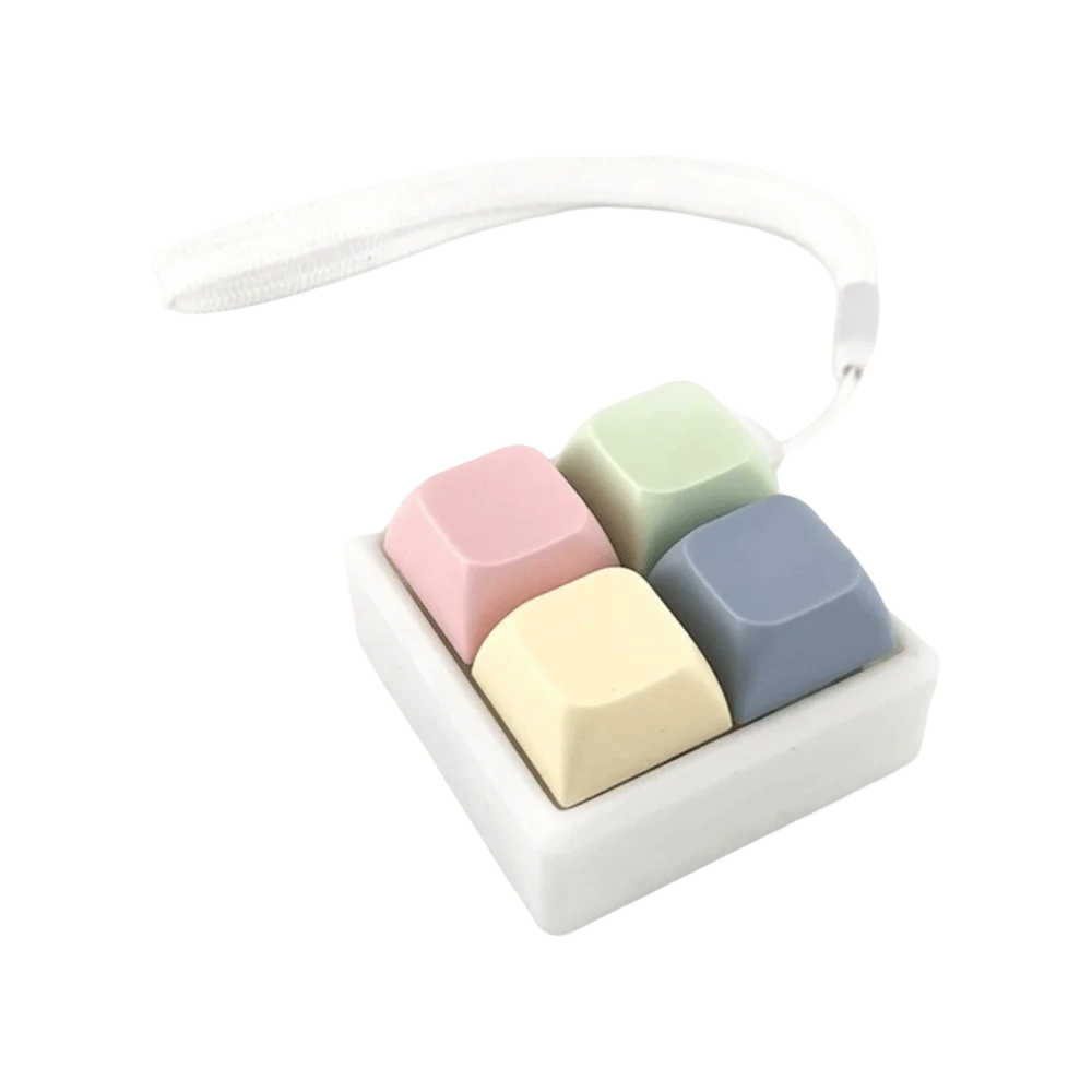 A white tactile stress relief keyboard fidget toy with five colored silicone keys inside.