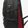 Black durable travel backpack shown from the back with a red accent panel.