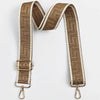 A tan and cream striped adjustable crossbody bag strap featuring a geometric maze pattern.