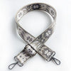 A beige and gray patterned jacquard strap for a crossbody bag, featuring a silver buckle.