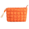 Orange quilted puffer makeup bag with a fabric strap