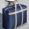 A navy blue foldable waterproof storage bag with tan straps is shown being carried.