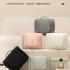 A collection of five colored TSLON hanging toiletry bags displayed on a white surface.
