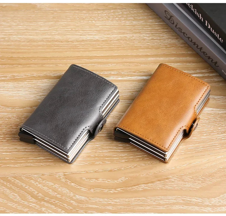 A pair of premium double layer ID card holder wallets in gray and tan leather resting on a light wooden surface.
