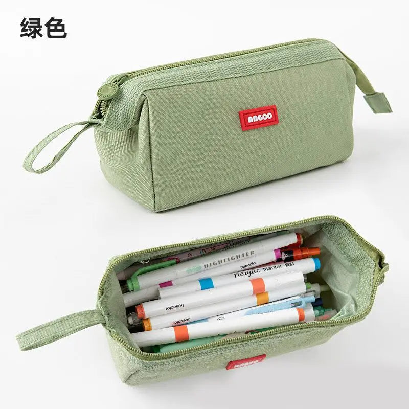 A light green minimalist pencil case with a zipper and a label holder is shown in a top-down view.